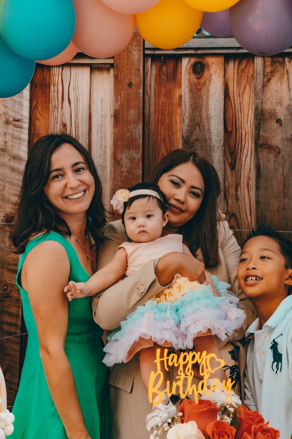 Two women, a boy and a baby celebrating birthday